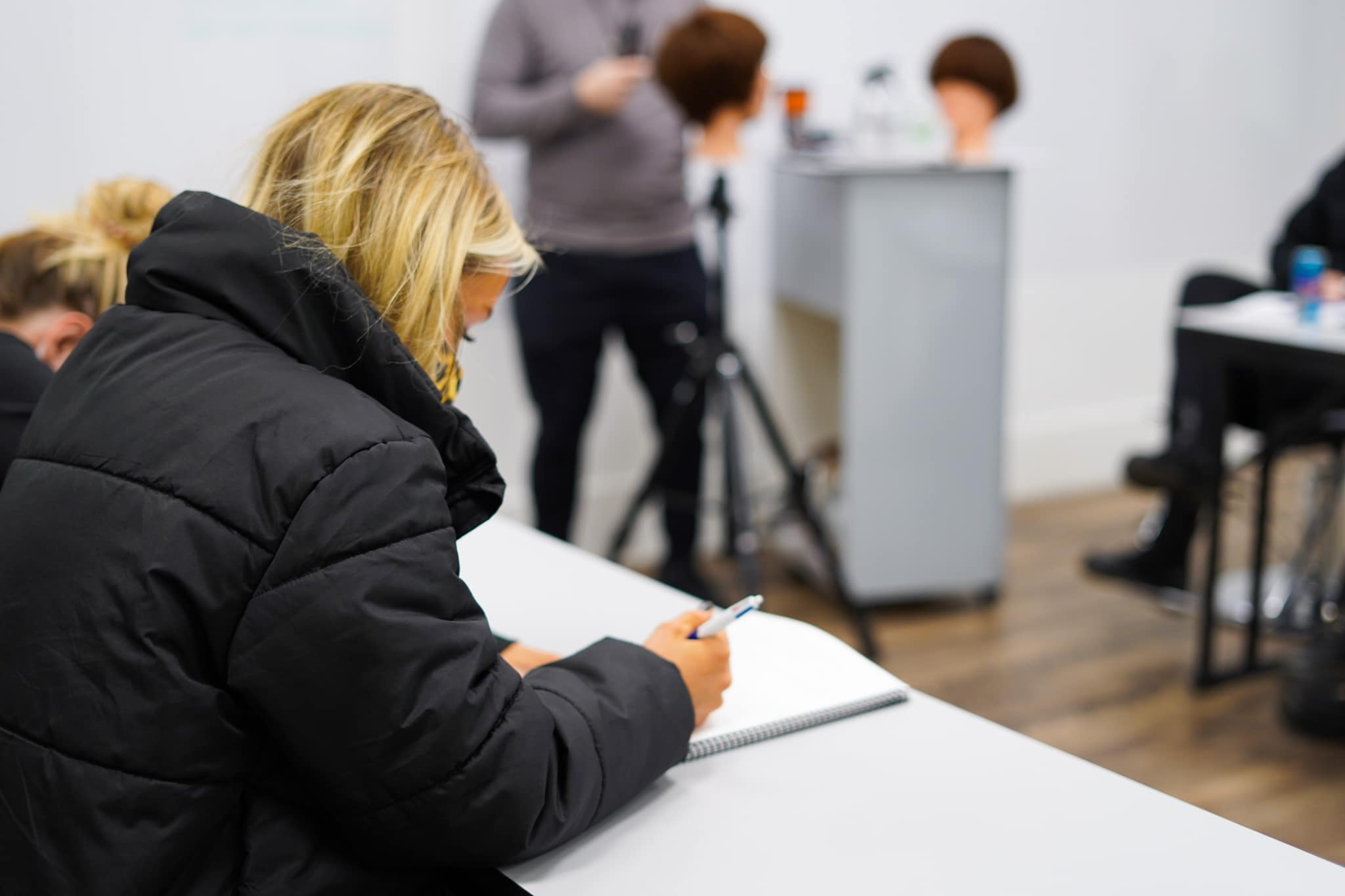woman taking notes in class at collectiv academy